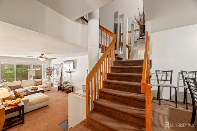 1103 Schmidt Ln, North Brunswick, NJ 08902 - staircase featuring carpet flooring, ceiling fan, and ornate columns