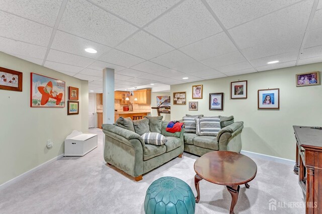 living room featuring a paneled ceiling and light colored carpet