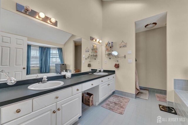 bathroom featuring tile patterned flooring and vanity