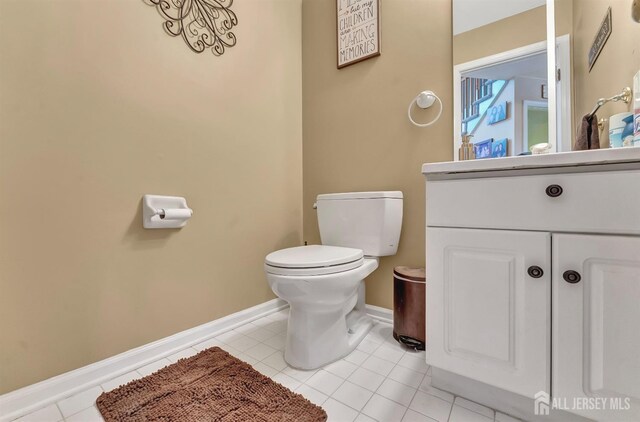 bathroom with tile patterned floors, vanity, and toilet