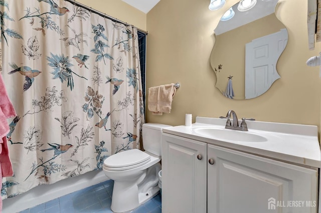 bathroom featuring a shower with curtain, vanity, tile patterned floors, and toilet