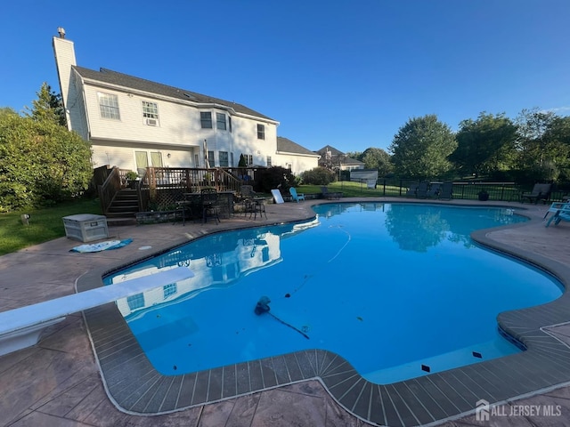 view of swimming pool featuring a wooden deck