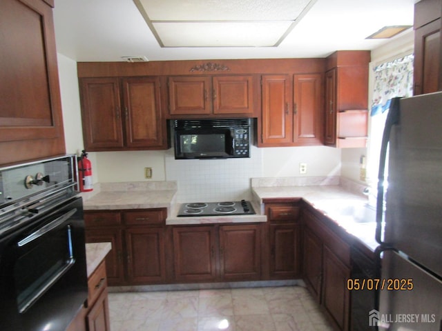 160 Pelham Ln Unit B, Monroe, NJ 08831 - kitchen with black appliances, light countertops, decorative backsplash, and light marble finish flooring
