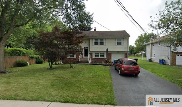 148 Dutton St, Franklin, NJ 08873 - view of front of home featuring driveway, an attached garage, and brick siding