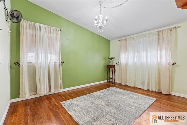 7 Piedmont Dr, Old Bridge, NJ 08857 - spare room featuring a chandelier, wood finished floors, and vaulted ceiling