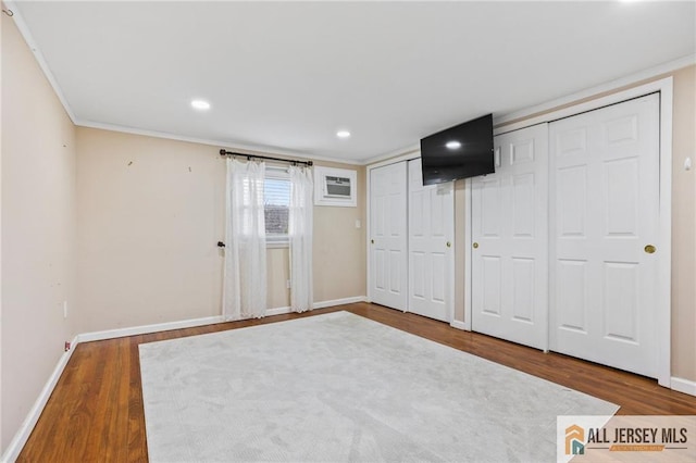 7 Piedmont Dr, Old Bridge, NJ 08857 - unfurnished bedroom featuring multiple closets, wood finished floors, an AC wall unit, ornamental molding, and recessed lighting