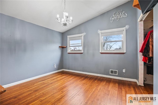 7 Piedmont Dr, Old Bridge, NJ 08857 - unfurnished room with a chandelier, hardwood / wood-style flooring, and lofted ceiling