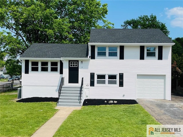 split level home featuring driveway, a garage, roof with shingles, and entry steps