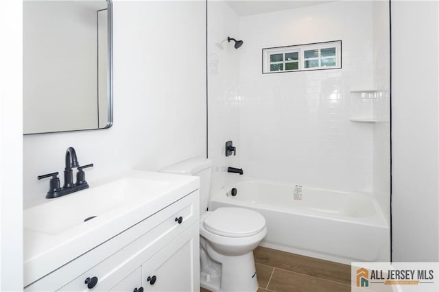 full bathroom featuring toilet, vanity, tub / shower combination, and wood finished floors