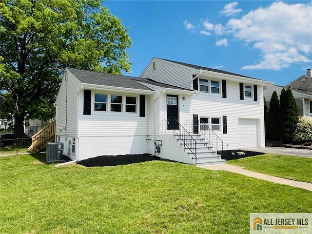 3 Tracy Dr, Fords, NJ 08863 - tri-level home with central AC, asphalt driveway, a garage, and a front yard
