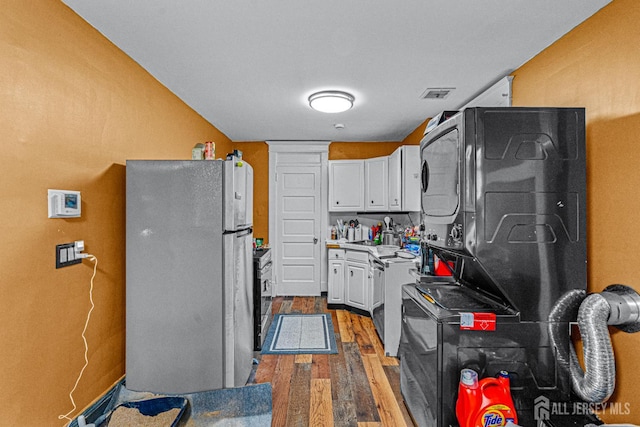 55 Suydam St, New Brunswick, NJ 08901 - kitchen featuring freestanding refrigerator, wood finished floors, white cabinetry, light countertops, and range