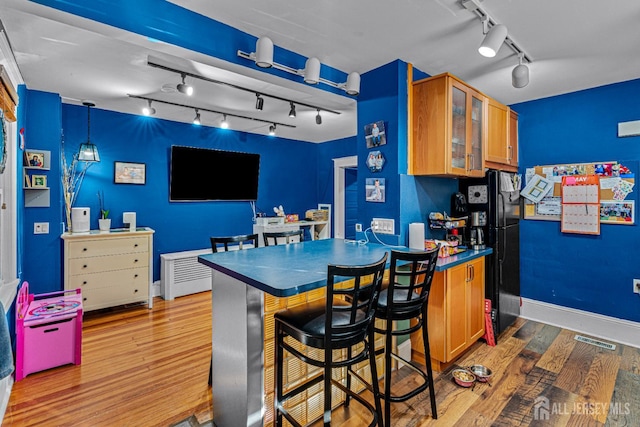 55 Suydam St, New Brunswick, NJ 08901 - kitchen with track lighting, freestanding refrigerator, dark countertops, and wood finished floors