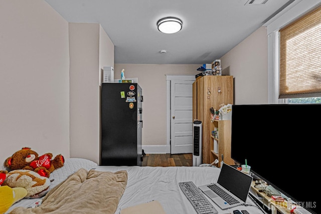 55 Suydam St, New Brunswick, NJ 08901 - bedroom featuring freestanding refrigerator, wood finished floors, and baseboards