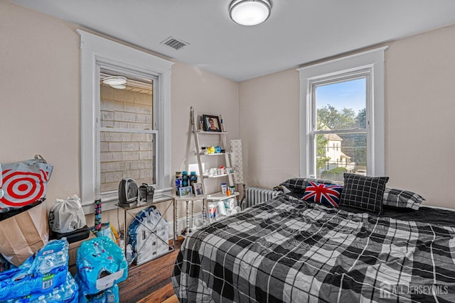 55 Suydam St, New Brunswick, NJ 08901 - bedroom featuring radiator and wood finished floors