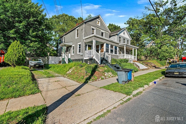 55 Suydam St, New Brunswick, NJ 08901 - view of front of house with a porch and driveway