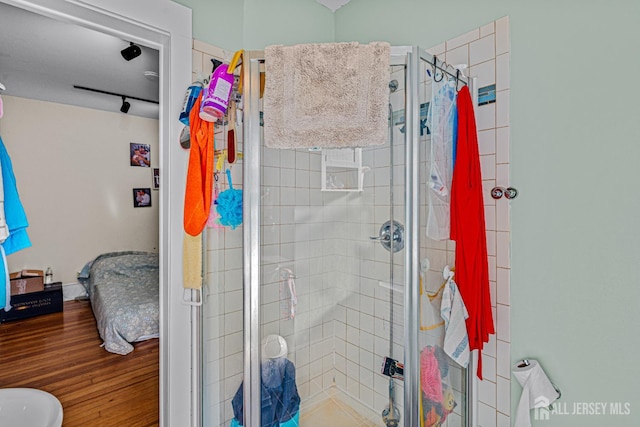 55 Suydam St, New Brunswick, NJ 08901 - bathroom featuring ensuite bathroom, a stall shower, and wood finished floors