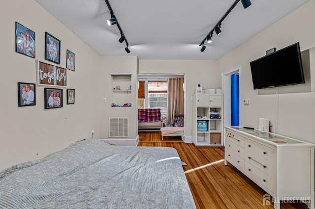 55 Suydam St, New Brunswick, NJ 08901 - bedroom with rail lighting, wood finished floors, and a ceiling fan