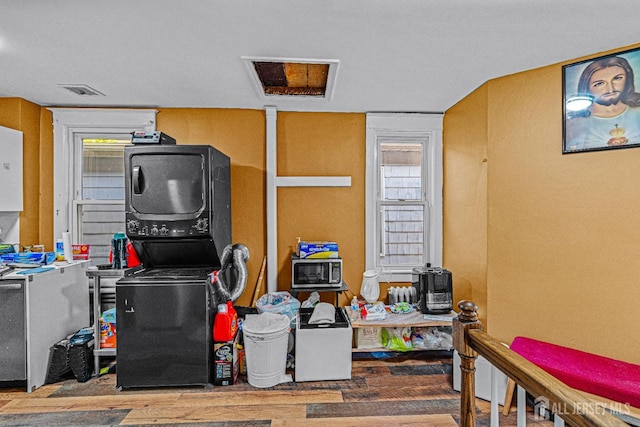 55 Suydam St, New Brunswick, NJ 08901 - misc room featuring stacked washer and clothes dryer, wood finished floors, and electric panel