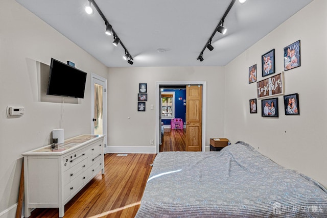 55 Suydam St, New Brunswick, NJ 08901 - bedroom with track lighting, light wood finished floors, and baseboards