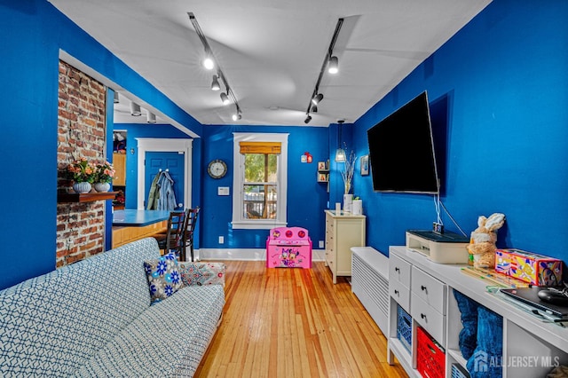 55 Suydam St, New Brunswick, NJ 08901 - living room with hardwood / wood-style flooring, rail lighting, and baseboards