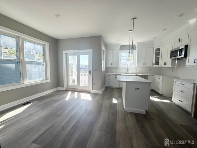 363 Ferris St, South Amboy, NJ 08879 - kitchen featuring visible vents, a sink, stainless steel microwave, dark wood-type flooring, and a kitchen island