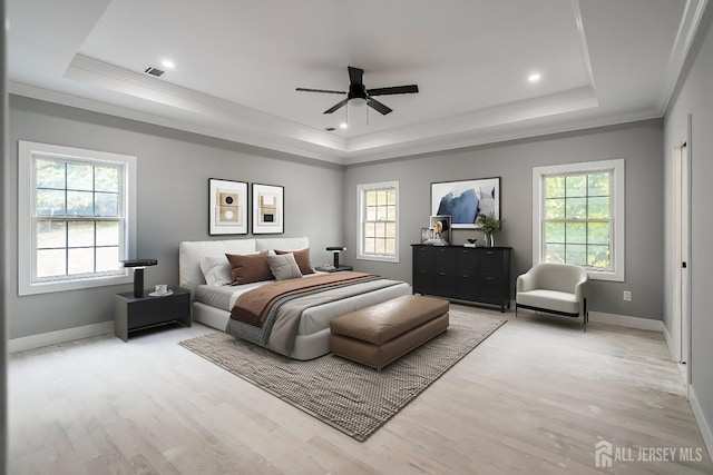 bedroom featuring a tray ceiling, ceiling fan, and hardwood / wood-style floors