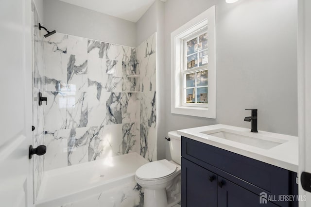 bathroom with vanity, toilet, and walk in shower