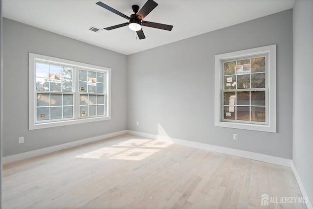 empty room with light hardwood / wood-style flooring and ceiling fan