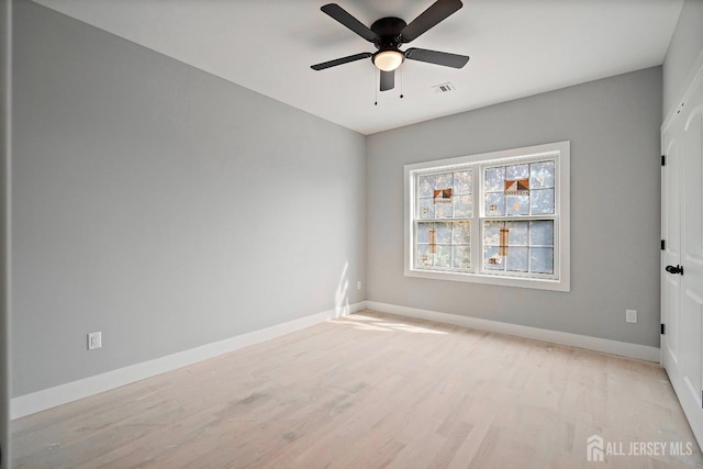 spare room with ceiling fan and light hardwood / wood-style floors