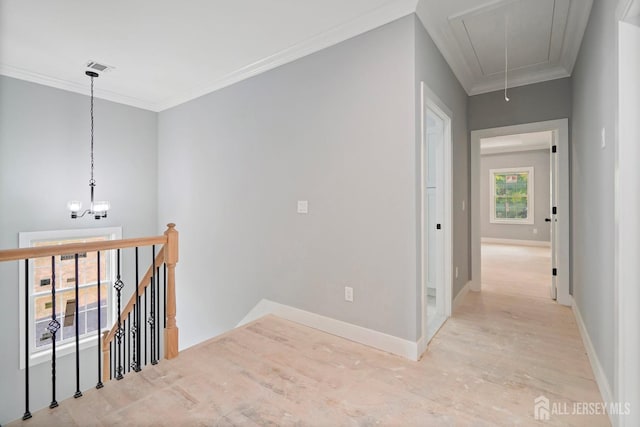 corridor with light wood-type flooring and crown molding