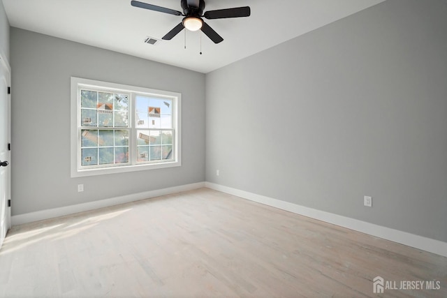 empty room featuring ceiling fan and light hardwood / wood-style floors