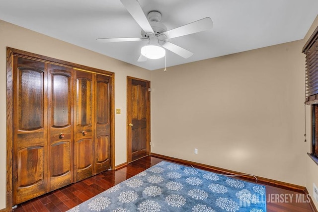 bedroom featuring ceiling fan, a closet, and dark hardwood / wood-style floors