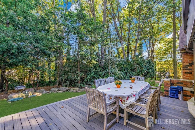 wooden deck with a lawn