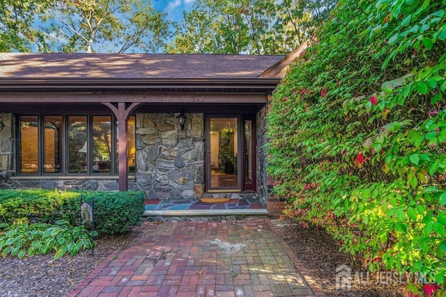 view of exterior entry featuring covered porch