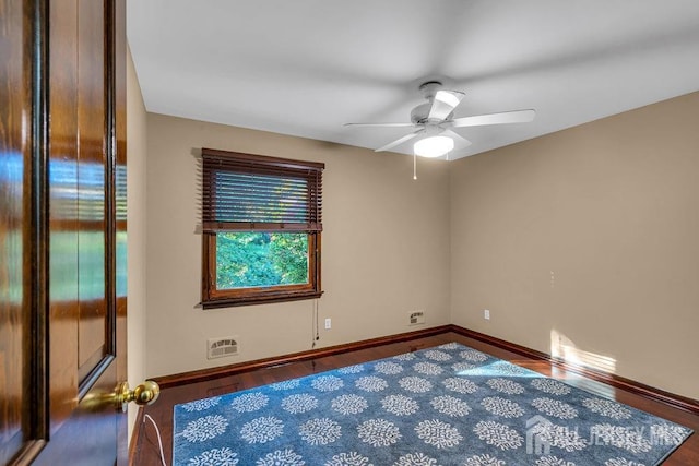 unfurnished room with ceiling fan and hardwood / wood-style flooring