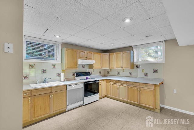 kitchen featuring sink, white appliances, light brown cabinetry, and tasteful backsplash