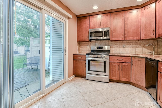 25 Sheffield Ct, North Brunswick, NJ 08902 - kitchen with appliances with stainless steel finishes, tasteful backsplash, brown cabinets, light stone countertops, and recessed lighting