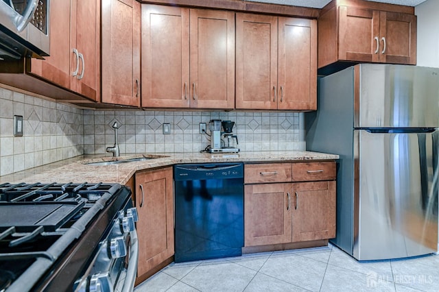 25 Sheffield Ct, North Brunswick, NJ 08902 - kitchen featuring stainless steel appliances, brown cabinetry, decorative backsplash, light tile patterned floors, and light stone counters