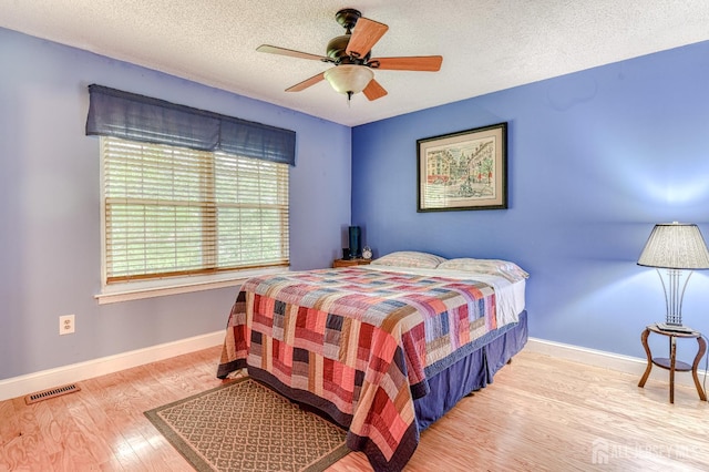 25 Sheffield Ct, North Brunswick, NJ 08902 - bedroom with wood finished floors, a textured ceiling, and a ceiling fan