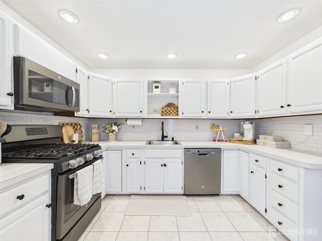 218 Washington Ave, Matawan, NJ 07747 - kitchen featuring appliances with stainless steel finishes, a sink, backsplash, white cabinets, and light countertops