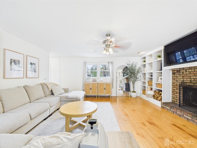 218 Washington Ave, Matawan, NJ 07747 - living room featuring a fireplace, wood finished floors, a ceiling fan, and built in features