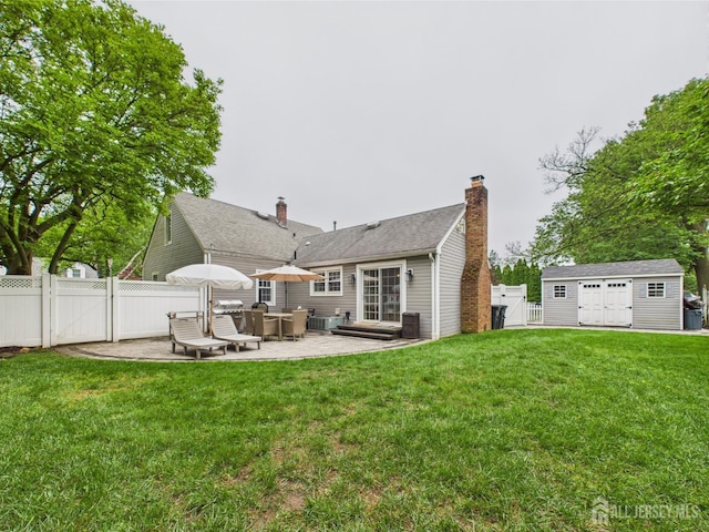 218 Washington Ave, Matawan, NJ 07747 - rear view of house with a gate, a patio area, a chimney, and an outbuilding