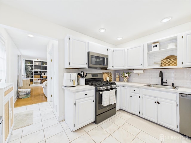 218 Washington Ave, Matawan, NJ 07747 - kitchen with stainless steel appliances, a sink, light tile patterned flooring, light countertops, and open shelves