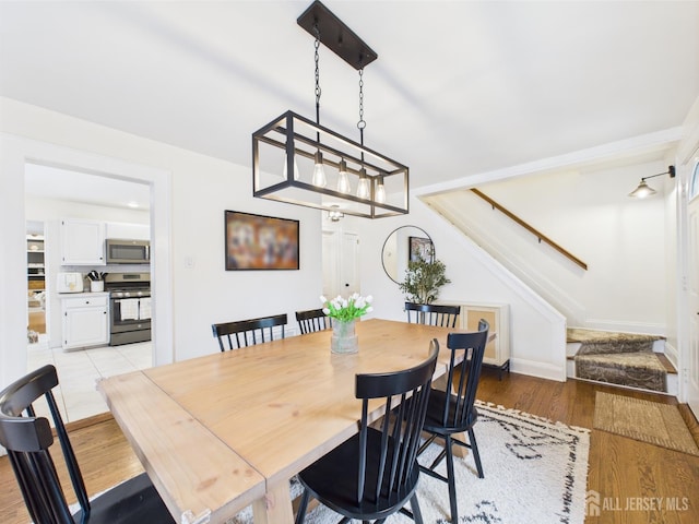 218 Washington Ave, Matawan, NJ 07747 - dining area with stairs and light wood-style flooring