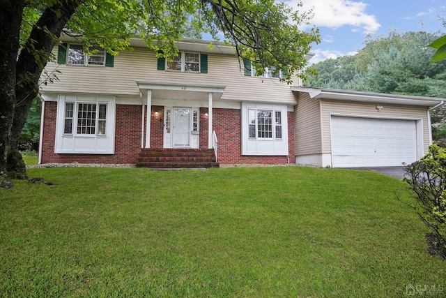 view of front of home featuring a front yard and a garage