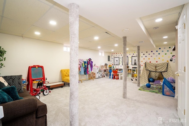 recreation room featuring a paneled ceiling and carpet floors