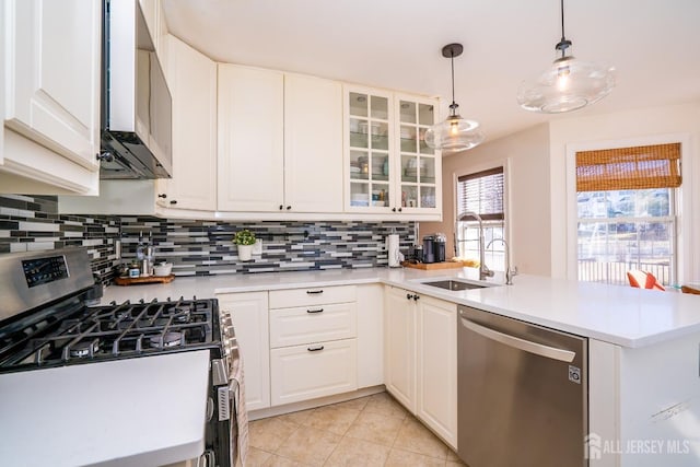 kitchen featuring sink, appliances with stainless steel finishes, hanging light fixtures, white cabinets, and kitchen peninsula