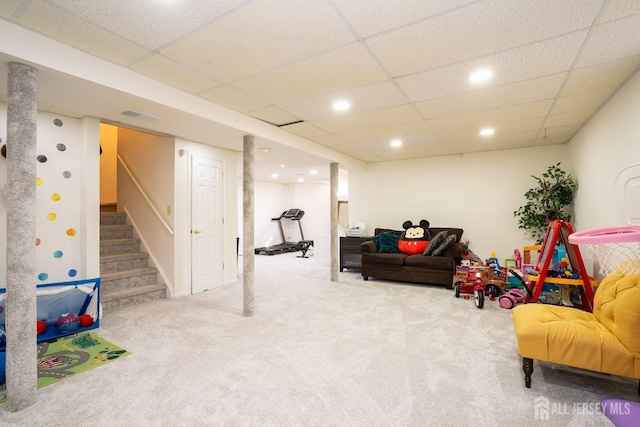 living room featuring a paneled ceiling and carpet flooring