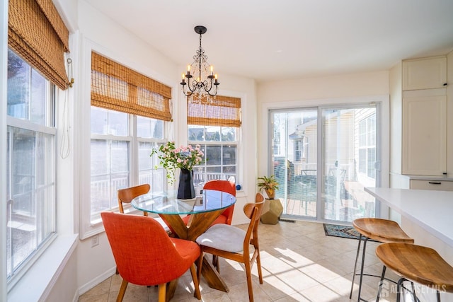 tiled dining room with an inviting chandelier