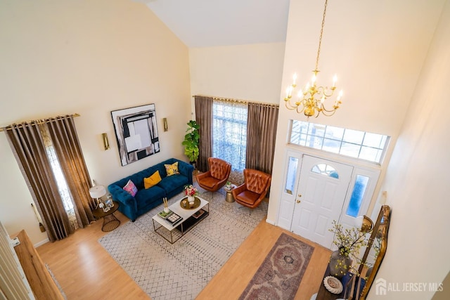 entryway featuring a notable chandelier, hardwood / wood-style floors, and a high ceiling